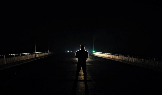 Man standing in dark street